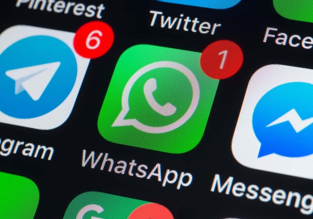 Logos of popular messengers on a smartphone background